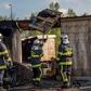 French firemen inspect a burnt hut at the Grande-Synthe migrant camp on the outskirts of Dunkirk, on April 11, 2017