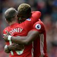Manchester United's midfielder Paul Pogba (R) embraces striker Wayne Rooney after scoring against Cyrstal Palace on May 21, 2017