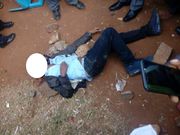 Naftali Njahi Kinuthia lays on the ground after he was stoned by bodaboda operators outside Moi Teaching and Referral Hospital (Twitter)