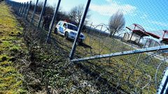 Local police officials patrol in front of a part of the border fence of the Hungarian-Croatian border at the Beremend border crossing point on February 23, 2017