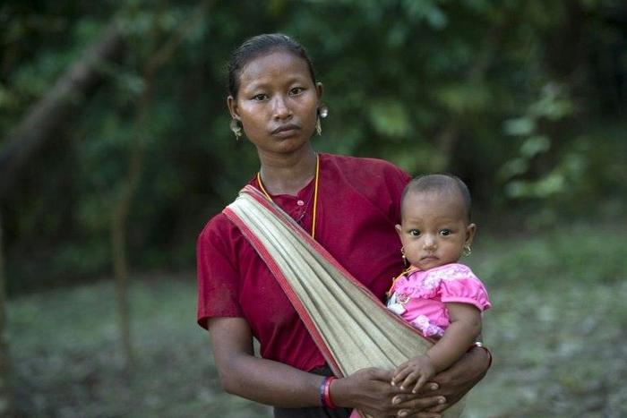 A displaced woman carries her child at a Buddhist monastery in Rakhine state near the Bangladesh border