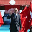 Turkish President Recep Tayyip Erdogan waves as he arrives to attend a ceremony marking the 102nd anniversary of the Canakkale Victory