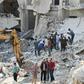 Syrian civil defence volunteers (C) search for victims amid the rubble of destroyed buildings on October 24, 2016, following overnight air strikes in the rebel-held town of Kafar Takharim, in Idlib province of northwest Syria