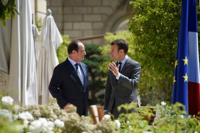 French President Francois Hollande (L), seen with now-presidential candidate Emmanuel Macron in 2015, said of possible campaign hacks, "We knew that there were these risks during the presidential campaign because it happened elsewhere"