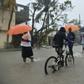 Haitian people travel in a flooded street through the rain, during a tropical storm in the commune of Les Cayes, Haiti, on October 21, 2016