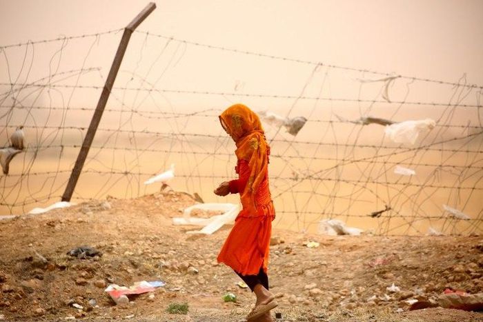 Monitors says more civilians are dying in US air strikes under President Donald Trump, particularly near the IS stronghold of Raqa. The Pentagon disputes that. A woman who was among Syrians who fled Raqa is seen here at a temporary camp