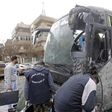 Syrian forensics experts examine a damaged bus following bomb attacks in Damascus' Old City on March 11, 2017