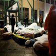 Refugees sleep outside the entrance of the Swedish Migration Agency's arrival center for asylum seekers at Jagersro in Malmo, Sweden, in November 2015