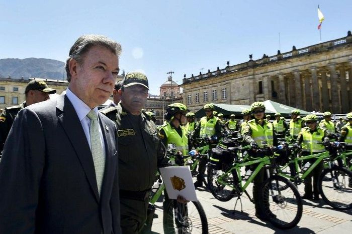 Colombian President Juan Manuel Santos (L) inspects new equipment for the National Police in Bogota, Colombia, on February 7, 2017