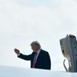 US President Donald Trump salutes before boarding Air Force One from MacDill Air Force Base on February 6, 2017 in Tampa, Florida