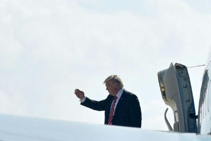 US President Donald Trump salutes before boarding Air Force One from MacDill Air Force Base on February 6, 2017 in Tampa, Florida