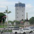 The 49-storey Torre de Manila high-rise condominium looms in the background from the Jose Rizal tomb and monument at Luneta Park in Manila