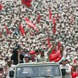 Venezuelan President Nicolas Maduro (C) saluting next to his wife Cilia Flores as they arrive for the celebrations for the seventh anniversary of the Bolivarian Militia in Caracas on April 17, 2017