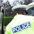 A traffic police officer inspects a matatu