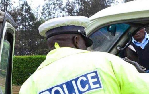 A traffic police officer inspects a matatu