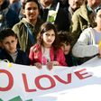 Children carry a banner during a commemorative march as Belgium marks the first anniversary of the twin Brussels attacks by Islamic extremists on March 22, 2017 in Brussels