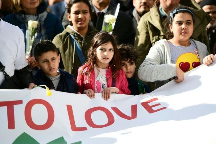 Children carry a banner during a commemorative march as Belgium marks the first anniversary of the twin Brussels attacks by Islamic extremists on March 22, 2017 in Brussels