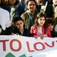 Children carry a banner during a commemorative march as Belgium marks the first anniversary of the twin Brussels attacks by Islamic extremists on March 22, 2017 in Brussels