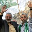 Freed Palestinian prisoner Yahya Sinwar (R), a founder of Hamas' military wing, and then Hamas leader Ismail Haniya wave as supporters celebrate the release of prisoners in Khan Yunis, southern Gaza Strip on October 21, 2011