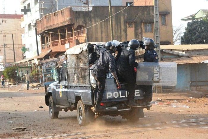 Policemen stand on a vehicle during a protest of teachers asking for wage increase on February 20, 2017 in Conakry