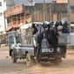 Policemen stand on a vehicle during a protest of teachers asking for wage increase on February 20, 2017 in Conakry
