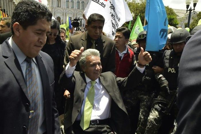 Ecuador's President-elect Lenin Moreno (C) greets supporters at the Plaza Grande in Quito on April 3, 2017