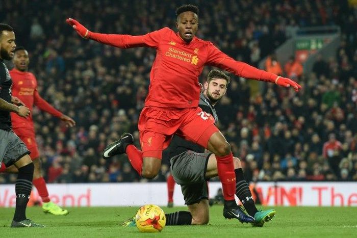 Liverpool striker Divock Origi (centre) is tackled by Southampton's Jack Stephens during their EFL Cup semi-final match between at Anfield in Liverpool on January 25, 2017