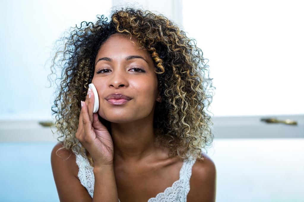 Lady cleaning her face (Courtesy)