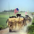 US forces accompanied by Kurdish People's Protection Units fighters (YPG) drive their armoured vehicles on April 28, 2017, near the village of Darbasiyah, Syria