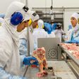 People work at a production line of the JBS-Friboi chicken processing plant during an inspection visit from Brazilian Agriculture Minister Blairo Maggi and technicians of the ministry in Lapa, Parana State, Brazil on March 21, 2017
