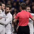 Real Madrid's Welsh forward Gareth Bale (L) argues with the referee as teammates try to stop him during their match against D Las Palmas at the Santiago Bernabeu stadium in Madrid on March 1, 2017