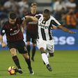 Juventus' Patrice Evra (R) vies for the ball with AC Milan's Fernandez Suso during the Italian Super Cup final match between AC Milan and Juventus in Doha on December 23, 2016