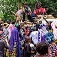 Central African internal-displaced people gather around a truck where volunteers distribute fire wood in Bangassou. At least 108 people were slaughtered and 76 injured during an attack by several hundred fighters on the town on May 13