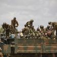 Soldiers of the Kenyan contingent serving with the African Union Mission in Somalia (AMISOM) load a truck as part of a resupply convoy in Dhobley, southern Somalia