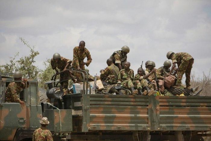 Soldiers of the Kenyan contingent serving with the African Union Mission in Somalia (AMISOM) load a truck as part of a resupply convoy in Dhobley, southern Somalia