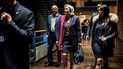 French presidential election candidate for the far-right Front National (FN) party Marine Le Pen (C) arrives at political rally to kick off her campaign next to her aide Catherine Griset (R) and bodyguard Thierry Legier (L) February 4, 2017