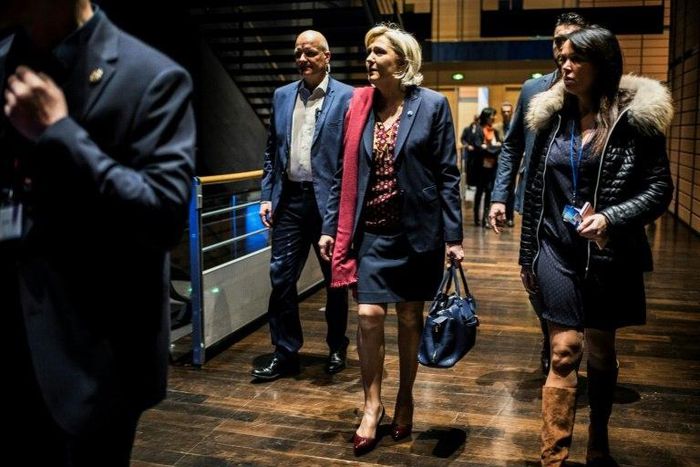 French presidential election candidate for the far-right Front National (FN) party Marine Le Pen (C) arrives at political rally to kick off her campaign next to her aide Catherine Griset (R) and bodyguard Thierry Legier (L) February 4, 2017