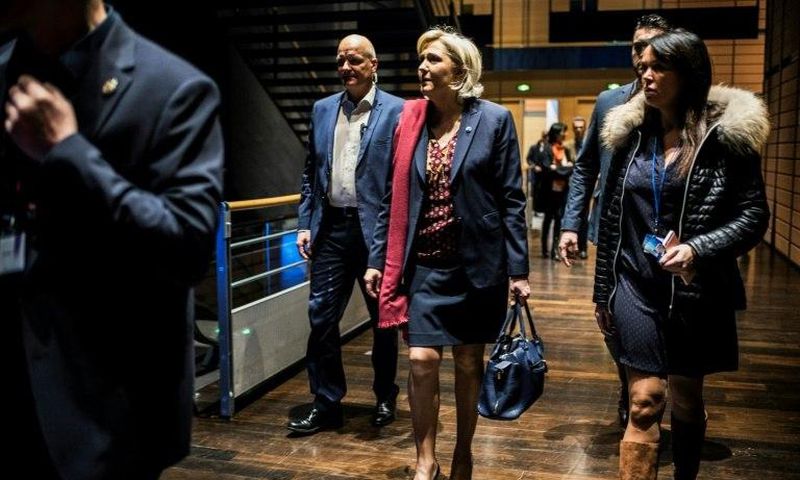 French presidential election candidate for the far-right Front National (FN) party Marine Le Pen (C) arrives at political rally to kick off her campaign next to her aide Catherine Griset (R) and bodyguard Thierry Legier (L) February 4, 2017