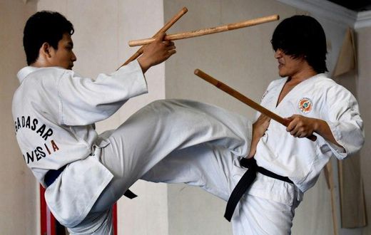 Students demonstrate their fighting skills with sticks during a training session in the ancient Indonesian martial art of "pencak silat" in Jakarta, Indonesia