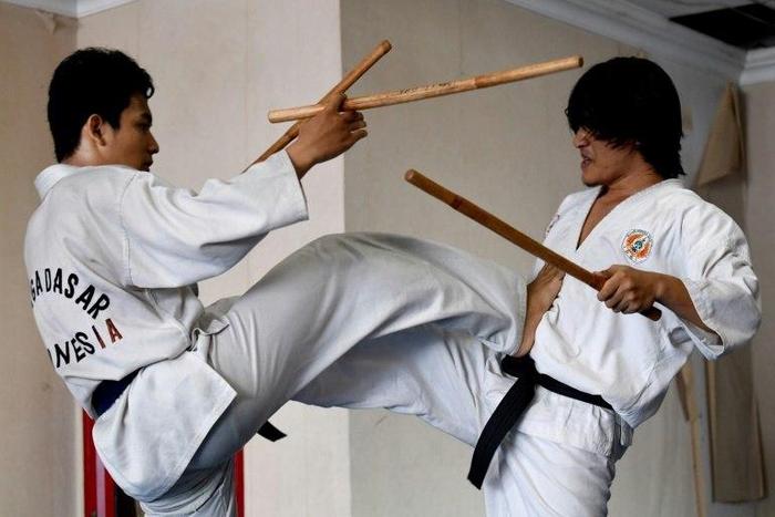 Students demonstrate their fighting skills with sticks during a training session in the ancient Indonesian martial art of "pencak silat" in Jakarta, Indonesia