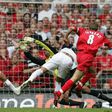 Liverpool's Steven Gerrard (R) puts the ball past West Ham goalkeeper Shaka Hislop to score during the FA Cup final at the Millennium Stadium in Cardiff, May 13, 2006