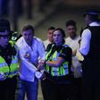 Police help people clear the scene after a terror attack on London Bridge on June 3, 2017