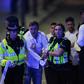 Police help people clear the scene after a terror attack on London Bridge on June 3, 2017