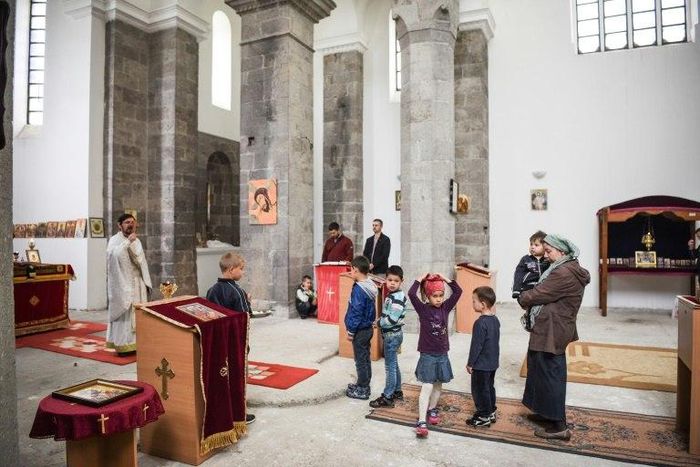 Father Nenad Stojanovic leads the Sunday mass on May 7, 2017 in the town of Mitrovica at St. Sava church in the Albanian part of a city that is sharply divided along ethnic lines