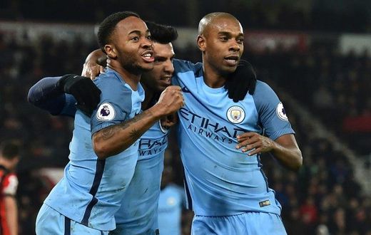 Manchester City's Sergio Aguero (C) celebrates with teammates Raheem Sterling (L) and Fernandinho after scoring a goal during their English Premier League match against Bournemouth, at the Vitality Stadium in Bournemouth, on February 13, 2017