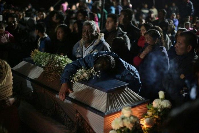 Family and friends mourn the death of their loved ones during the massive wake in San Isidro Chilchotla, Puebla state, Mexico on May 9, 2017, after an explosion at a fireworks warehouse killed 14, all but three of them children
