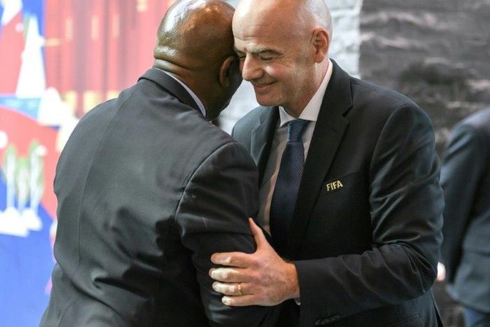 Head of FIFA's monitoring mission on the Israel-Palestinian issue of football, South Africa's Tokyo Sexwale (L)hugs FIFA President Gianni Infantino after a meeting of the FIFA Council on October 14, 2016