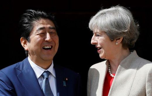 Britain's Prime Minister Theresa May (R) welcomes Japan's Prime Minister Shinzo Abe (L) at Chequers, the prime minister's official country residence, near Ellesborough, northwest of London, on April 28, 2017