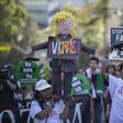A woman carries a pinata based on Donald Trump during one of several May Day marches in Los Angeles, California