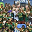 Cameroon team players and coach Hugo Broos (C) celebrate with the winner's trophy after beating Egypt 2-1 to win the 2017 Africa Cup of Nations final football match on February 5, 2017